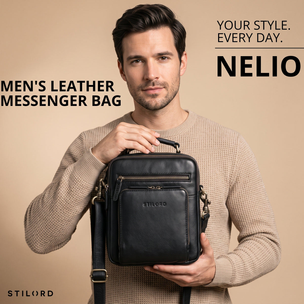Small black leather crossbody bag with top handle and front zip pocket, STILORD embossing, man holding it front-facing