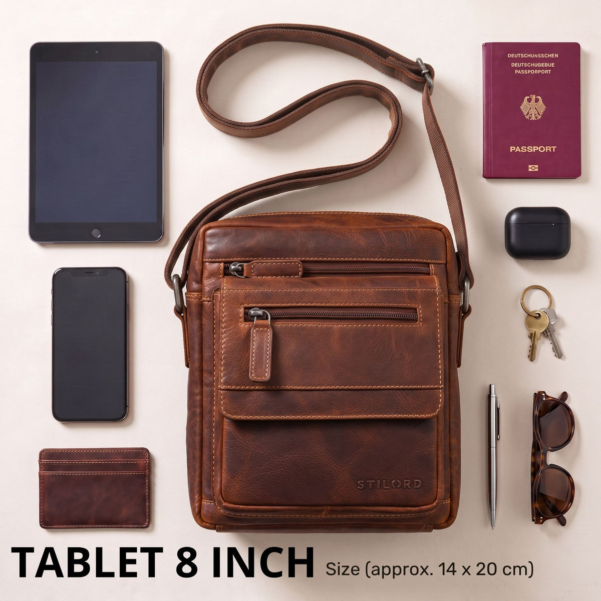 Small flat men's leather crossbody in salerno brown, front view with zip pockets, 8-inch tablet and STILORD embossing