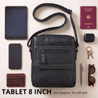 Flat black leather crossbody bag front view with zip pockets, 8-inch tablet and everyday items arranged around it