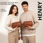 Two models hold a maraska brown leather toiletry bag, front view, visible STILORD embossing