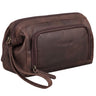 Brown leather toiletry bag Henry with embossed STILORD logo, front pocket and wrist strap, angled side view