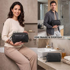 Black leather toiletry bag with STILORD embossing and wrist strap, shown in bathroom and held by models