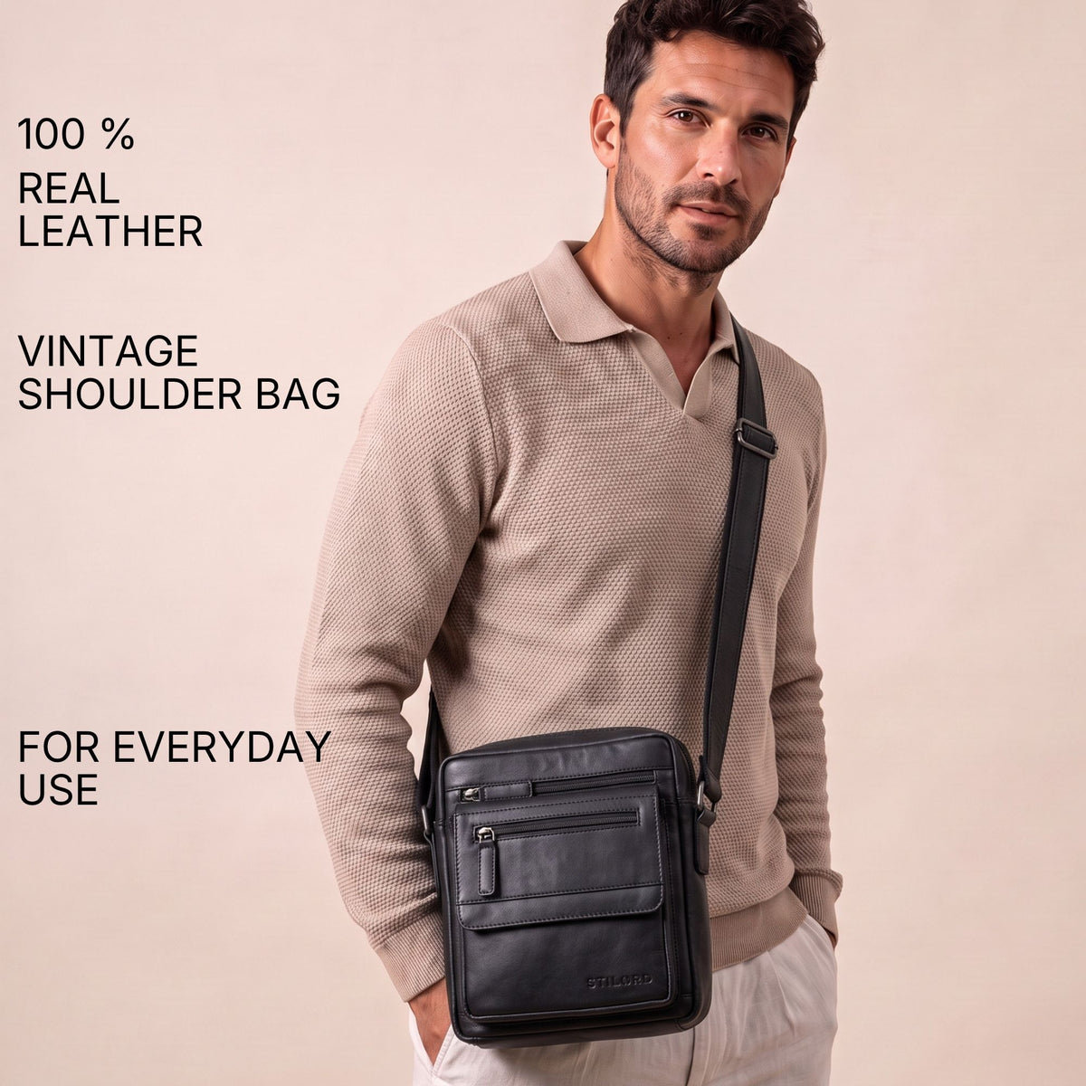 Slim black leather crossbody shoulder bag worn by man, front view, zip pockets visible, fits 8-inch tablet